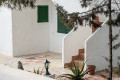 Outdoor chair beside a white Mediterranean terrace wall