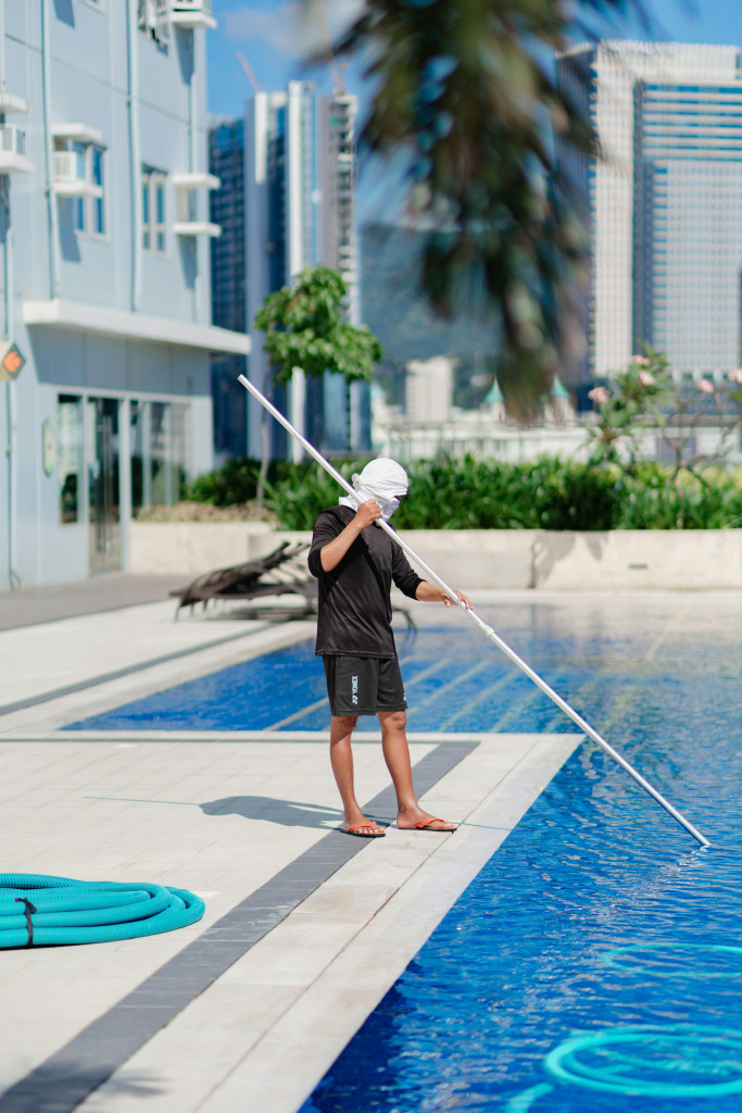 Professional pool maintenance at a residential property